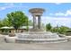 A tiered fountain with ornate details, set in a landscaped square under a blue sky at 710 Samuel Cary Dr, Cary, NC 27511