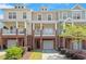 Charming townhome exterior with brick accents, inviting porches, and well-manicured landscaping at 710 Samuel Cary Dr, Cary, NC 27511