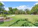 Expansive green front yard leading to a charming home with mature trees and colorful flowers enhancing its curb appeal at 710 Samuel Cary Dr, Cary, NC 27511