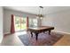 Versatile room with large window, pool table, and stylish chandelier, ready for entertainment at 710 Samuel Cary Dr, Cary, NC 27511