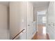 Upstairs hallway with hardwood floors, multiple doors, and neutral paint at 710 Samuel Cary Dr, Cary, NC 27511