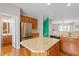 Bright kitchen with stainless steel refrigerator and a convenient center island with granite countertop at 710 Samuel Cary Dr, Cary, NC 27511