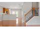 Open living area features wood floors, staircase, and kitchen access at 710 Samuel Cary Dr, Cary, NC 27511