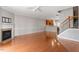 Open-concept living room with hardwood floors, fireplace, and adjacent kitchen area at 710 Samuel Cary Dr, Cary, NC 27511