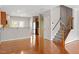 Spacious living room with hardwood floors, staircase, and an open-concept design at 710 Samuel Cary Dr, Cary, NC 27511