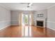 Cozy living room featuring a fireplace, hardwood floors, and French doors at 710 Samuel Cary Dr, Cary, NC 27511