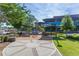 Charming outdoor seating area with shaded tables and benches, offering a relaxing space to enjoy the lush green surroundings at 710 Samuel Cary Dr, Cary, NC 27511