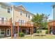 Townhome back exterior featuring private wooden decks perfect for outdoor relaxation and entertainment at 710 Samuel Cary Dr, Cary, NC 27511