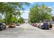 Street view with parked cars and lush trees, leading to a prominent brick building in the distance at 710 Samuel Cary Dr, Cary, NC 27511