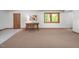 Spacious basement area with a wooden desk and a window view at 7723 Johnson Mill Rd, Bahama, NC 27503