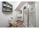 Cozy bathroom with a toilet, sink, shower, and shelving for storage at 7723 Johnson Mill Rd, Bahama, NC 27503