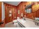 Bathroom with wood paneling, white vanity, and updated fixtures at 7723 Johnson Mill Rd, Bahama, NC 27503