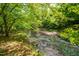 A serene creek flows through the property, offering a peaceful and scenic view at 7723 Johnson Mill Rd, Bahama, NC 27503
