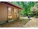 The exterior of the home features a door, windows, and a grill for outdoor cooking at 7723 Johnson Mill Rd, Bahama, NC 27503