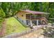 Exterior angled view of a two-story home with a screened-in porch and lush backyard at 7723 Johnson Mill Rd, Bahama, NC 27503