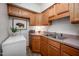 A charming kitchen with oak cabinets, a vintage vibe and stainless steel sink basin at 7723 Johnson Mill Rd, Bahama, NC 27503