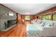 Spacious living room with hardwood floors, cozy seating, and a charming fireplace at 7723 Johnson Mill Rd, Bahama, NC 27503