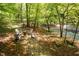 Relaxing outdoor seating area near a tranquil creek, perfect for enjoying nature at 7723 Johnson Mill Rd, Bahama, NC 27503