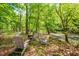 Cozy outdoor seating area with a fire pit, ideal for gatherings by the creek at 7723 Johnson Mill Rd, Bahama, NC 27503