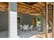 Covered patio area offers a shady retreat with outdoor seating and a view of the yard at 7723 Johnson Mill Rd, Bahama, NC 27503