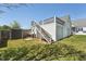 Backyard features a 2-car garage with steps leading to a rooftop deck, plus a shed for extra storage at 79 Blande Dr, Kenly, NC 27542