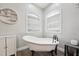 Claw foot tub under arched windows offers a vintage touch to this updated bathroom at 79 Blande Dr, Kenly, NC 27542