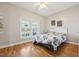 Bright bedroom with wood floors and two windows provides a comfortable and inviting space at 79 Blande Dr, Kenly, NC 27542