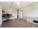 Bright bedroom featuring sleek gray flooring, complemented by a ceiling fan and modern furniture at 79 Blande Dr, Kenly, NC 27542