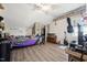 Cozy bedroom featuring a unique brick accent wall and quirky decor, illuminated by a ceiling fan at 79 Blande Dr, Kenly, NC 27542