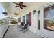 Inviting front porch with ceiling fans, seating, and decorative accents, perfect for relaxing outdoors at 79 Blande Dr, Kenly, NC 27542