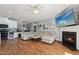 Inviting living room with a fireplace, a large sectional, hardwood floors, and updated appliances at 79 Blande Dr, Kenly, NC 27542