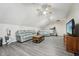 Spacious living room with a ceiling fan, a cozy seating area, and a treadmill in the background at 79 Blande Dr, Kenly, NC 27542