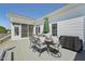 Outdoor patio featuring a dining set, grill, and screened door for entertaining at 79 Blande Dr, Kenly, NC 27542