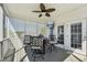 Covered back porch with comfortable seating, ceiling fan, and screened wall at 79 Blande Dr, Kenly, NC 27542