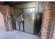 Brick entrance gate with artistic metalwork and concrete stairs, blending security with design at 807 W Trinity Ave # 144, Durham, NC 27701