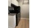 Modern kitchen with a black oven, gray backsplash, and white cabinetry, seamlessly blending style at 807 W Trinity Ave # 144, Durham, NC 27701