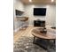 Entertainment area with mounted TV, modern furniture, and rustic accent pieces at 807 W Trinity Ave # 144, Durham, NC 27701