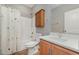 Bathroom featuring wood cabinets, white countertops, and a shower with a curtain at 809 Amarillo Rose Ln, Durham, NC 27712