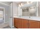 Bathroom featuring double sinks, a large mirror, and modern lighting at 809 Amarillo Rose Ln, Durham, NC 27712