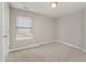 Cozy bedroom with neutral walls, carpeted floors, and a window allowing ample natural light at 809 Amarillo Rose Ln, Durham, NC 27712