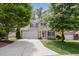 Charming two-story home with a manicured lawn, a two-car garage, and a welcoming red front door at 809 Amarillo Rose Ln, Durham, NC 27712