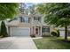 Inviting two-story home with a well-kept lawn, a two-car garage, and a striking red front door at 809 Amarillo Rose Ln, Durham, NC 27712