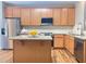 Modern kitchen with stainless steel appliances and a granite-topped central island at 809 Amarillo Rose Ln, Durham, NC 27712