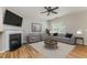 Inviting living room with a fireplace, plush seating, and a ceiling fan at 809 Amarillo Rose Ln, Durham, NC 27712