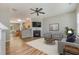 Open-concept living room featuring a fireplace and seamless flow into the kitchen at 809 Amarillo Rose Ln, Durham, NC 27712