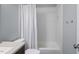 Bathroom showcases a shower-tub combo with white tile surround and updated fixtures at 815 Carpenter Town Ln, Cary, NC 27519