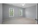 This bedroom features neutral walls, carpet, and a ceiling fan for comfortable living at 815 Carpenter Town Ln, Cary, NC 27519