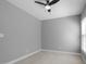 A clean bedroom featuring a ceiling fan, neutral walls, carpet, and a bright window at 815 Carpenter Town Ln, Cary, NC 27519