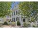 A light blue two-story home stands out with its classic design and trimmed landscaping at 815 Carpenter Town Ln, Cary, NC 27519