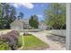 Beautiful home exterior with a well-manicured lawn, white picket fence, and mature trees at 815 Carpenter Town Ln, Cary, NC 27519